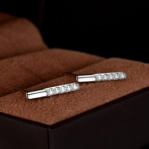 Elegant S925 sterling silver baguette earrings with sparkling moissanite on brown velvet