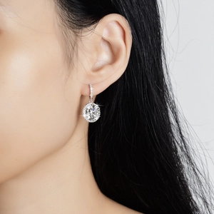 Elegant S925 silver 5 carat moissanite halo drop earrings worn by a model on a light background