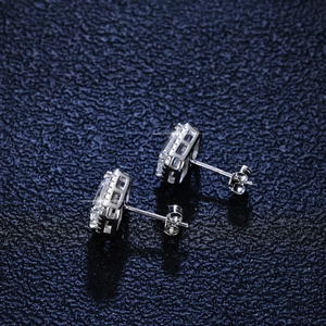 S925 sterling silver emerald-cut moissanite stud earrings with filigree detail on blue leather