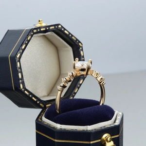 Champagne gold Moissanite ring with six-prong crown setting in a premium blue velvet box