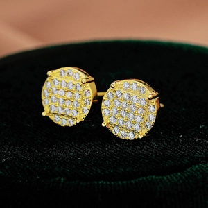 Macro detail of gold S925 silver stud earrings featuring brilliant round moissanite pavé