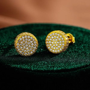 Macro shot of gold-plated S925 silver round stud earrings with iced-out moissanite stones