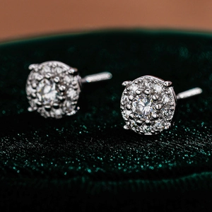 Macro detail of round moissanite stud earrings in S925 sterling silver with halo stones