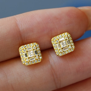 Macro shot of S925 sterling silver square moissanite stud earrings with gold finish