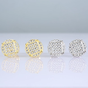 Macro detail of round micro-paved moissanite earrings in gold and silver finishes
