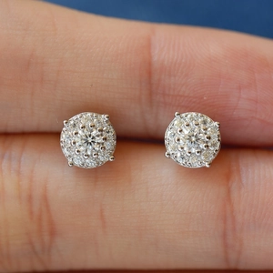 Classic S925 sterling silver round moissanite stud earrings shown held by fingers