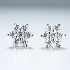 Macro shot of 925 silver moissanite flower stud earrings with brilliant round cut stones