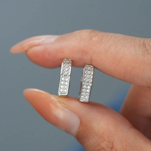 Close-up of S925 sterling silver rectangular hoop earrings with pavé moissanite stones