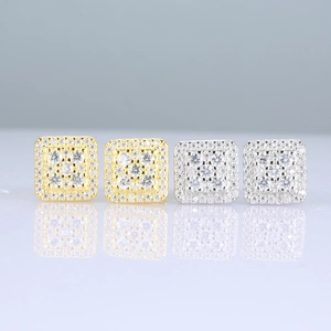 Close-up of square iced out stud earrings in gold and silver with shimmering Moissanite