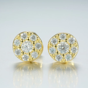 Close-up of gold moissanite stud earrings with round pavé setting and central stone