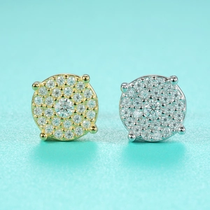 Detailed view of silver and gold moissanite stud earrings with micro-pave setting