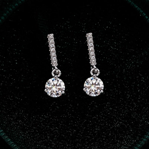 Macro detail of S925 sterling silver drop earrings with moissanite stones and pavé setting