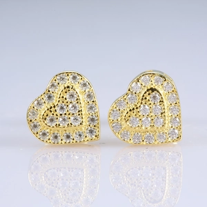 Detailed close-up of heart-shaped gold studs featuring exquisite micro-pave setting