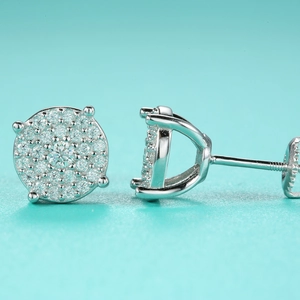 Detailed macro view of silver moissanite stud earrings showing prong setting and screw back