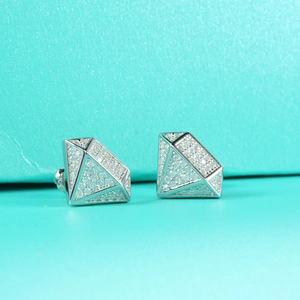 Macro shot of 3D geometric diamond-shaped S925 sterling silver studs with pavé moissanite