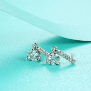 Detailed macro shot of S925 sterling silver moissanite stud earrings with tassel drop style