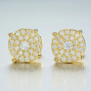 Detailed macro view of gold-plated moissanite stud earrings with micro-pave setting