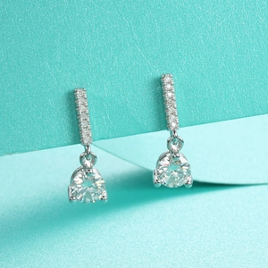 Detail of S925 sterling silver drop earrings with moissanite pave and round cut stones