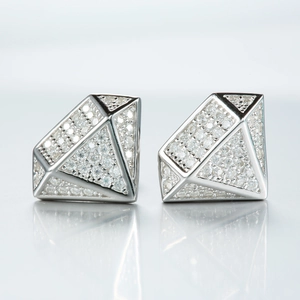 Macro shot of silver diamond-shaped geometric earrings with sparkling moissanite stones