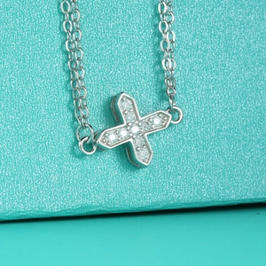 S925 sterling silver cross bracelet with sparkling moissanite on a blue background