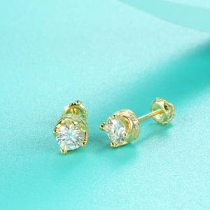 Macro shot of 925 silver moissanite stud earrings with a 6-prong setting and side accents