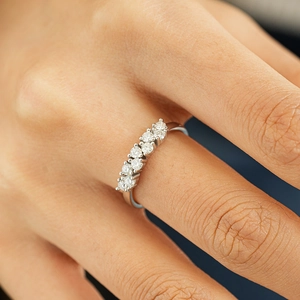 Asymmetrical S925 sterling silver eternity ring with seven sparkling round moissanite stones