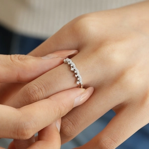 Close-up of S925 sterling silver crown ring featuring sparkling moissanite on a model finger