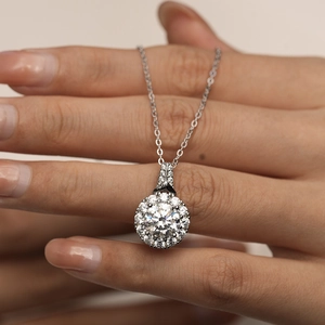 Detailed view of a round-cut moissanite pendant on a s925 sterling silver chain