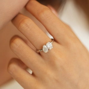 Close-up of 925 sterling silver Toi et Moi ring with pear and emerald cut moissanite