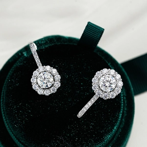 Classic 925 sterling silver halo stud earrings featuring D color moissanite in a green box
