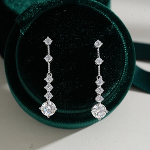 925 silver moissanite drop earrings with graduated brilliant stones in a green velvet box