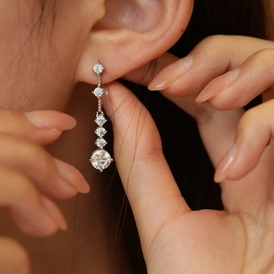 925 silver moissanite drop earrings with five graduated round stones on female model
