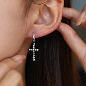 Elegant S925 sterling silver cross earrings with moissanite stones on a female model