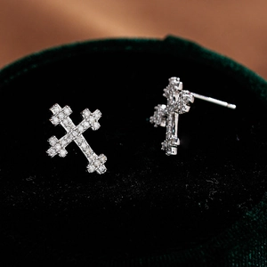 Sparkling S925 sterling silver cross earrings with full moissanite stones on green velvet