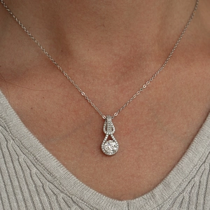 925 silver necklace featuring a 1 carat moissanite halo pendant on a model neck