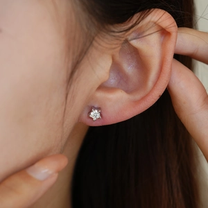 Classic S925 sterling silver pentagram moissanite stud earring worn by a model