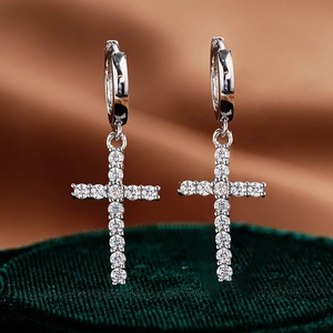 Sparkling S925 sterling silver cross earrings with full moissanite stones on green velvet