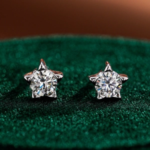 Luxury S925 sterling silver star-shaped moissanite stud earrings on green velvet background