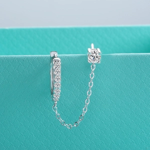 Vue macro d'une boucle d'oreille moissanite en argent 925 avec chaîne reliée