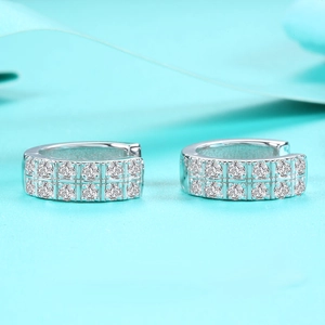 Macro view of silver S925 sterling silver hoop earrings with double row moissanite stones