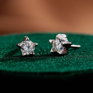 Macro detail of star-shaped S925 sterling silver stud earrings with moissanite center