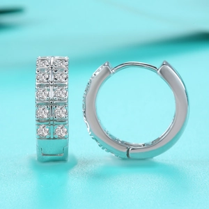 Macro shot of S925 sterling silver hoop earrings featuring double rows of moissanite stones