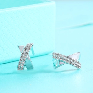 Macro detail of S925 silver criss-cross earrings with pavé set micro-zirconia stones