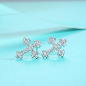 Macro shot of sterling silver cross earrings with shimmering full diamond micro-pave