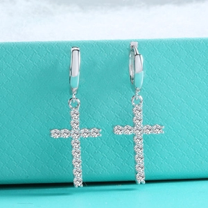 Detailed close-up of s925 silver drop earrings featuring cross shaped moissanite stones