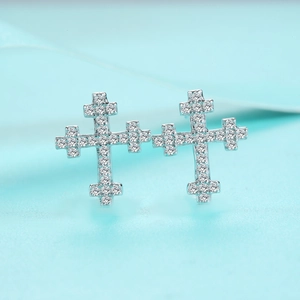 Close-up of S925 sterling silver cross earrings with pavé moissanite stones