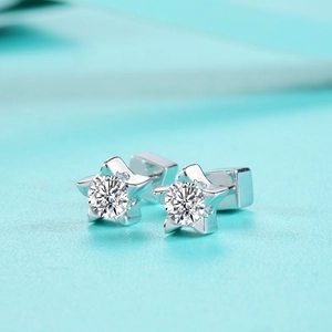 Detailed macro view of S925 sterling silver star-shaped stud earrings with moissanite stones