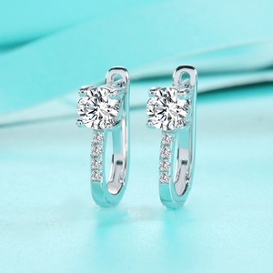 Macro detail of U-shaped S925 silver moissanite earrings with a 4-prong round cut setting