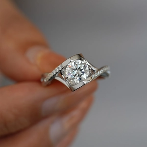 Elegant S925 sterling silver moissanite engagement ring with twisted pavé band design