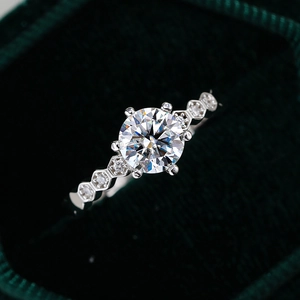 Elegant 1 carat moissanite honeycomb silver wedding ring on dark green velvet box